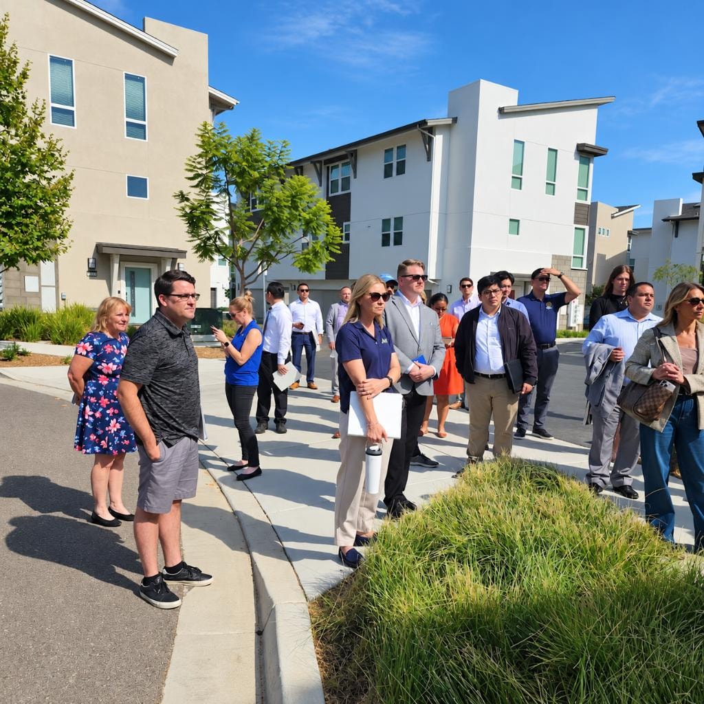 Academy participants on a field tour of a modern housing community